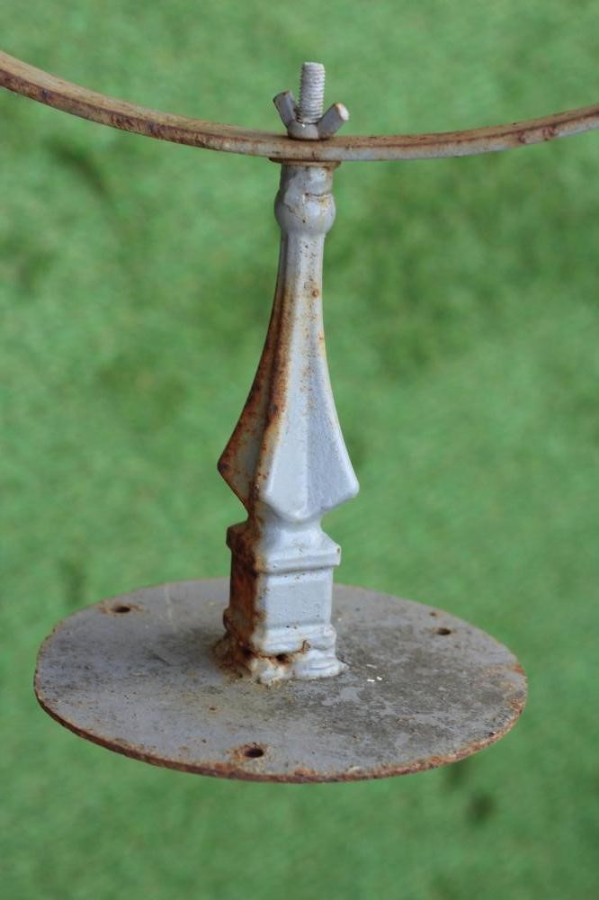 A WROUGHT IRON ARMILLARY SPHERE with spear head finial, on triangular stem and circular base, 28 Image