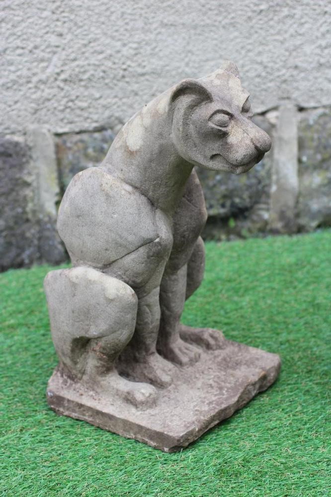 A CARVED SANDSTONE MODEL OF A WILD CAT seated on a rustic oblong base, 8 1/2" x 16 1/2", together Image