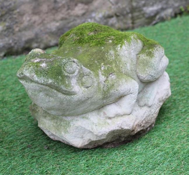 A CARVED SANDSTONE MODEL OF A WILD CAT seated on a rustic oblong base, 8 1/2" x 16 1/2", together Image