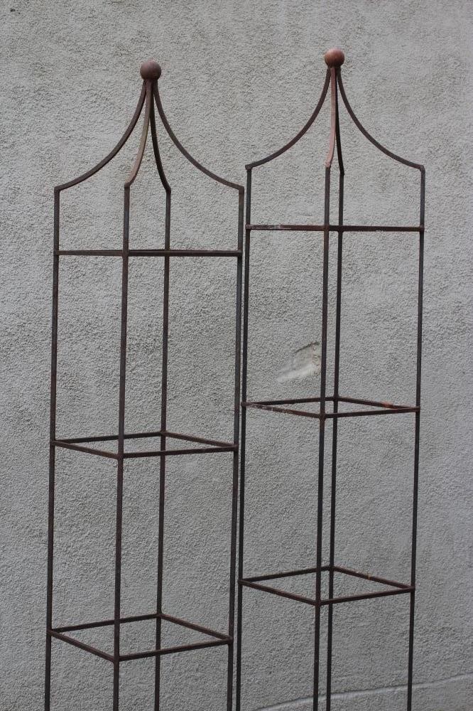 A PAIR OF WROUGHT IRON PLANT OBELISKS of square form, the pyramidal top with ball finial, rust Image