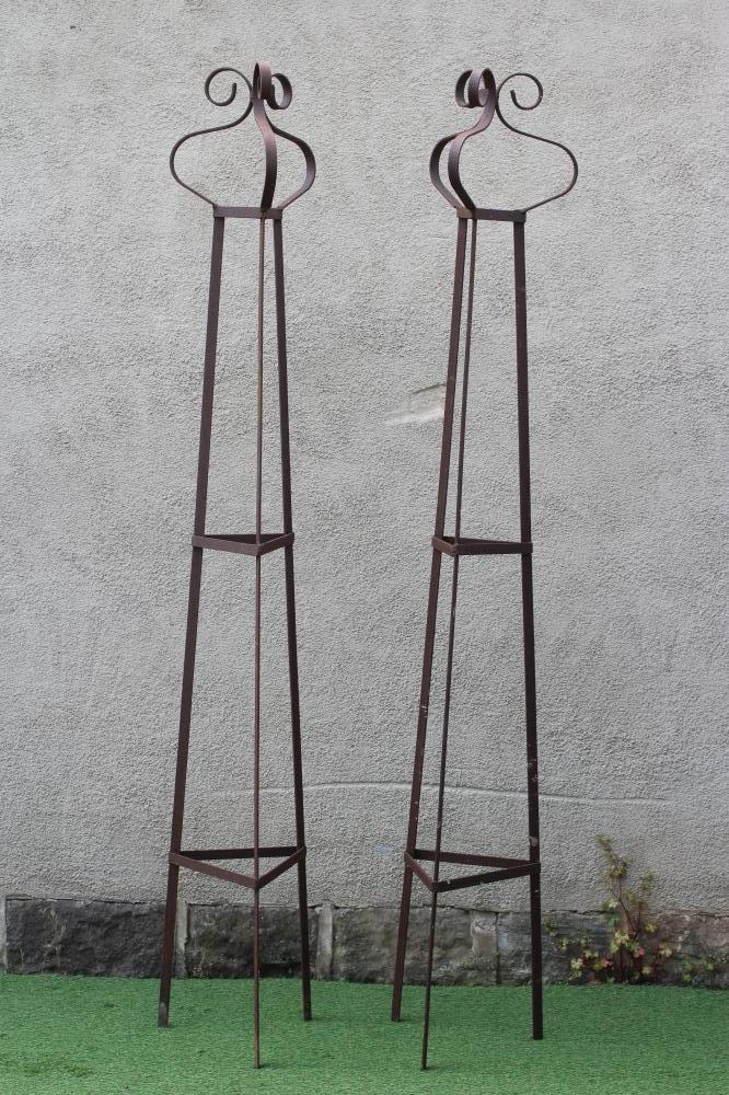 A PAIR OF WROUGHT IRON PLANT OBELISKS of tapering triangular form with scroll finials, rust Image
