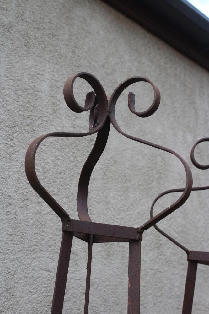 A PAIR OF WROUGHT IRON PLANT OBELISKS of tapering triangular form with scroll finials, rust Image