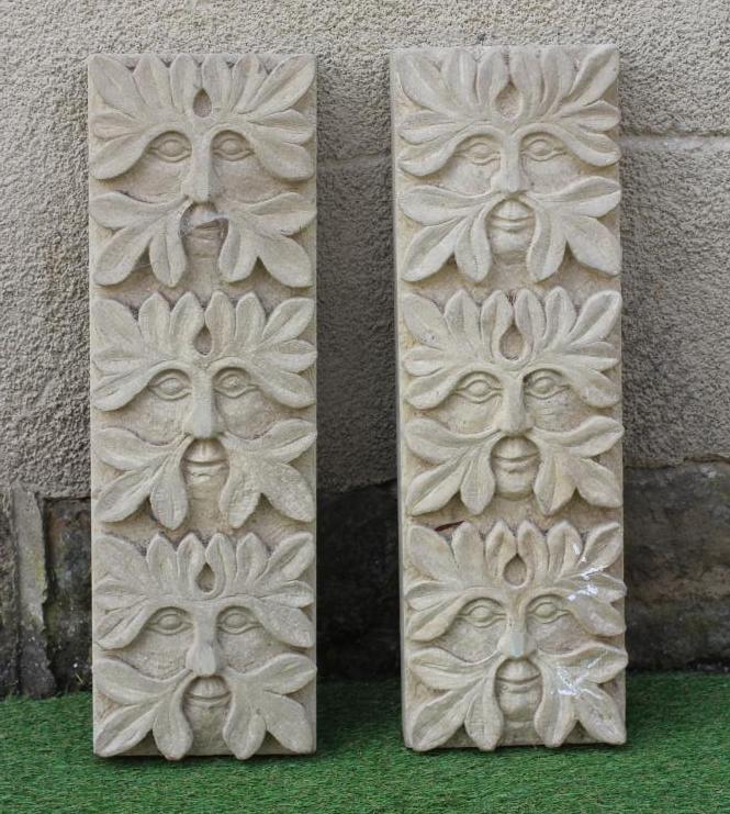 A PAIR OF CARVED SANDSTONE GREEN MAN WALL PANELS of oblong form each with three masks, 8" x 25" Image
