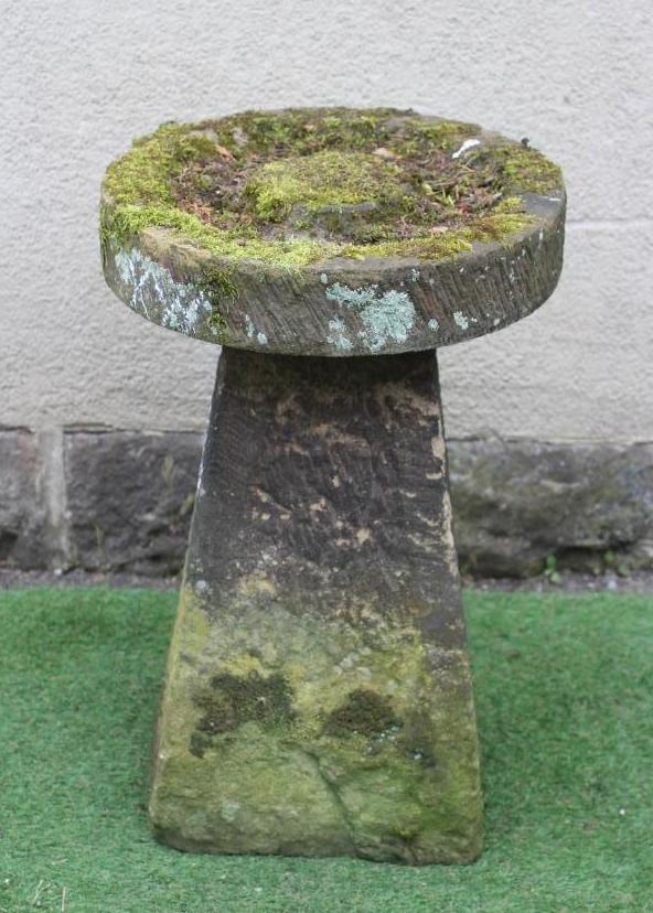 A SANDSTONE BIRD BATH, the circular top with central boss raised on a square tapering stem, 19 1/2" Image
