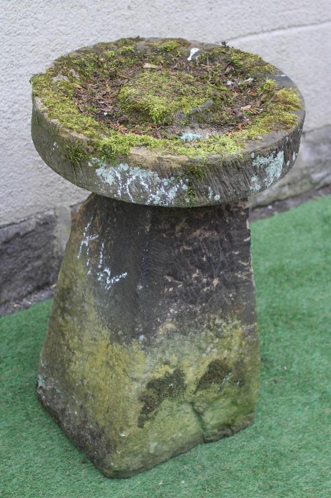 A SANDSTONE BIRD BATH, the circular top with central boss raised on a square tapering stem, 19 1/2" Image