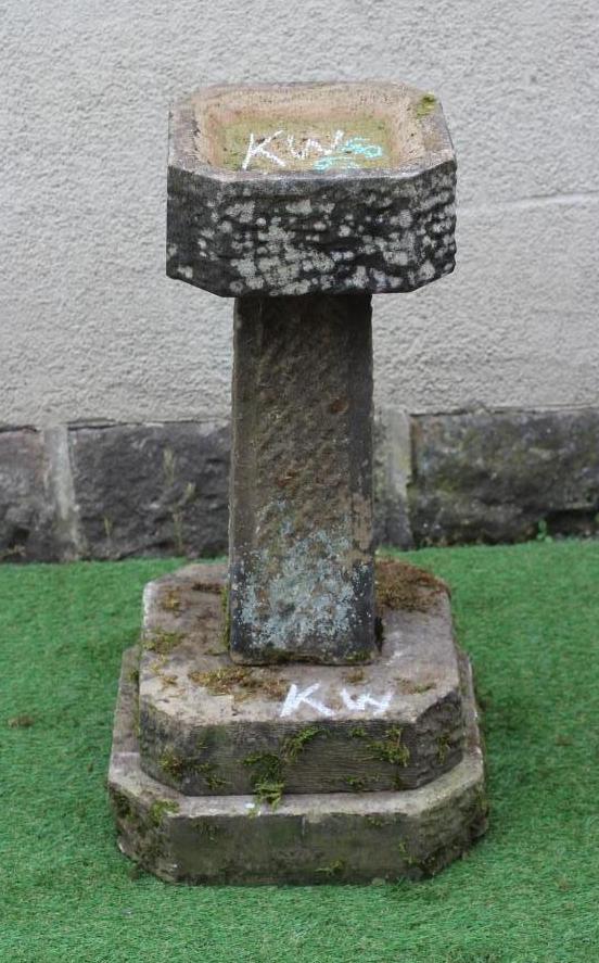 A SANDSTONE BIRD BATH, the finely cut canted square basin raised on tapering stem and stepped canted Image