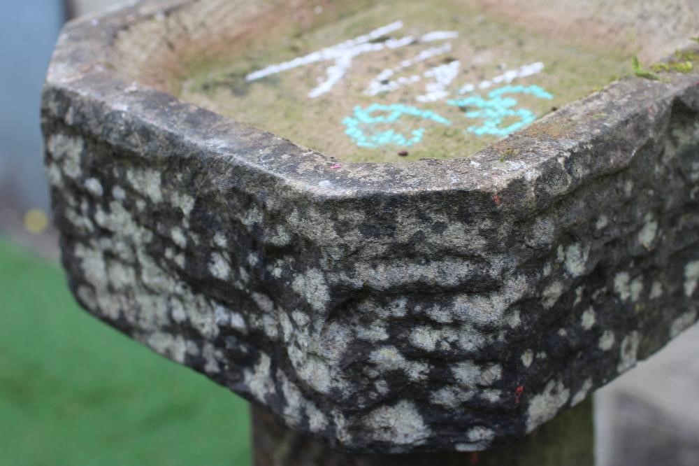 A SANDSTONE BIRD BATH, the finely cut canted square basin raised on tapering stem and stepped canted Image