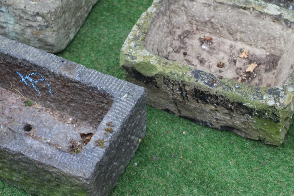A SMALL SANDSTONE TROUGH of rough hewn oblong form, 18" x 12"x 8", another, 20" x 11"x 7 3/4", and a Image