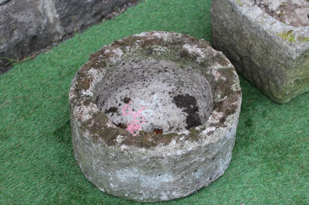 A SANDSTONE TROUGH of rough hewn circular form, 15 1/2" x 8", together with another of oblong form, Image