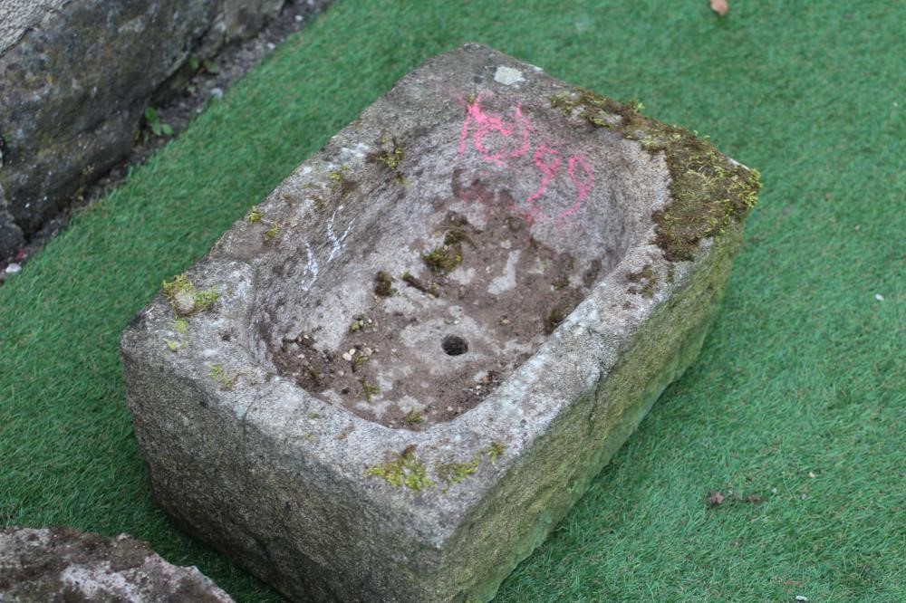 A SANDSTONE TROUGH of rough hewn circular form, 15 1/2" x 8", together with another of oblong form, Image