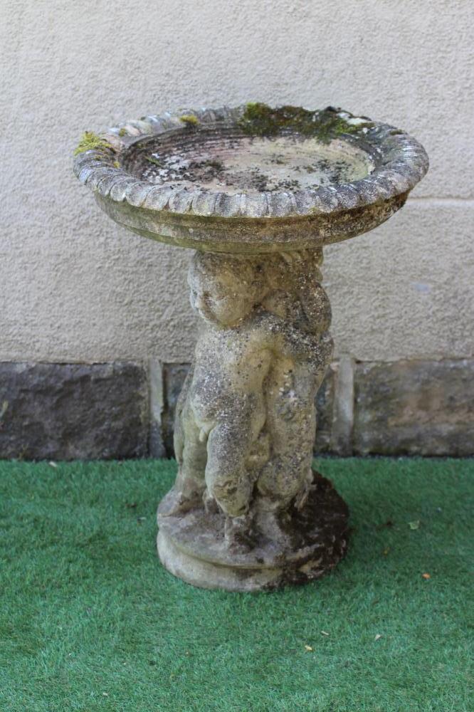 A HADDONSTONE BIRD BATH, the moulded circular bowl with ovolu rim held aloft by three putti, on Image