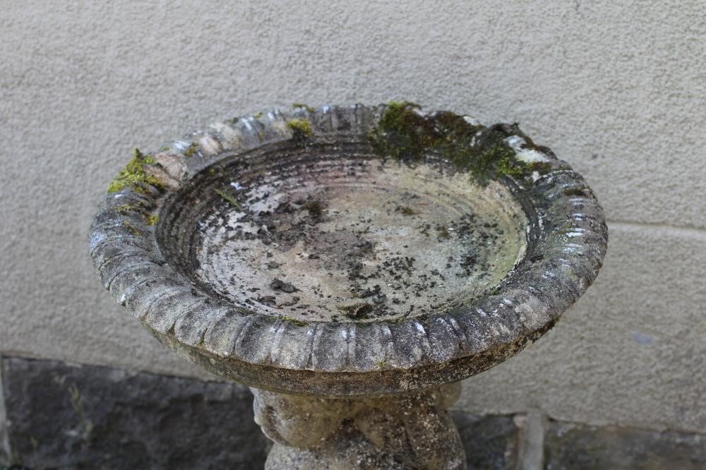 A HADDONSTONE BIRD BATH, the moulded circular bowl with ovolu rim held aloft by three putti, on Image
