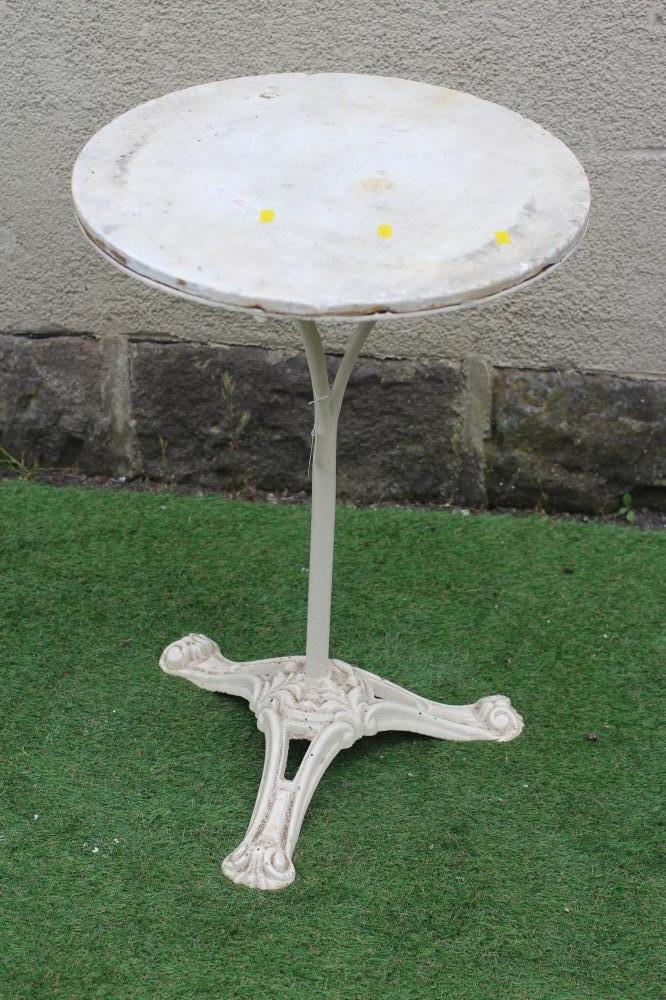 A CAST IRON BISTRO TABLE, the circular white marble top on plain turned stem, raised on scrolled and Image