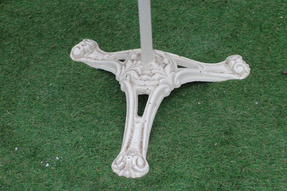 A CAST IRON BISTRO TABLE, the circular white marble top on plain turned stem, raised on scrolled and Image