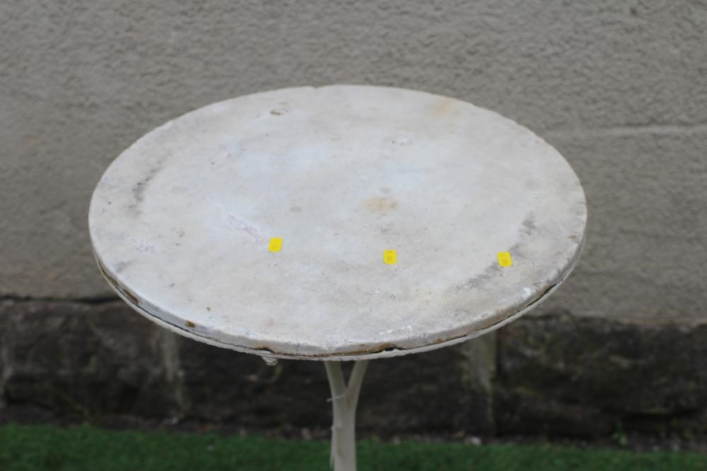 A CAST IRON BISTRO TABLE, the circular white marble top on plain turned stem, raised on scrolled and Image