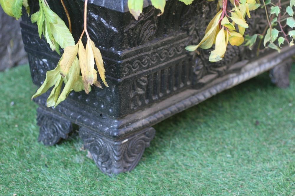 A PAIR OF CAST IRON JARDINIERES of oblong tapering form with flared rim on foliate bracket feet Image