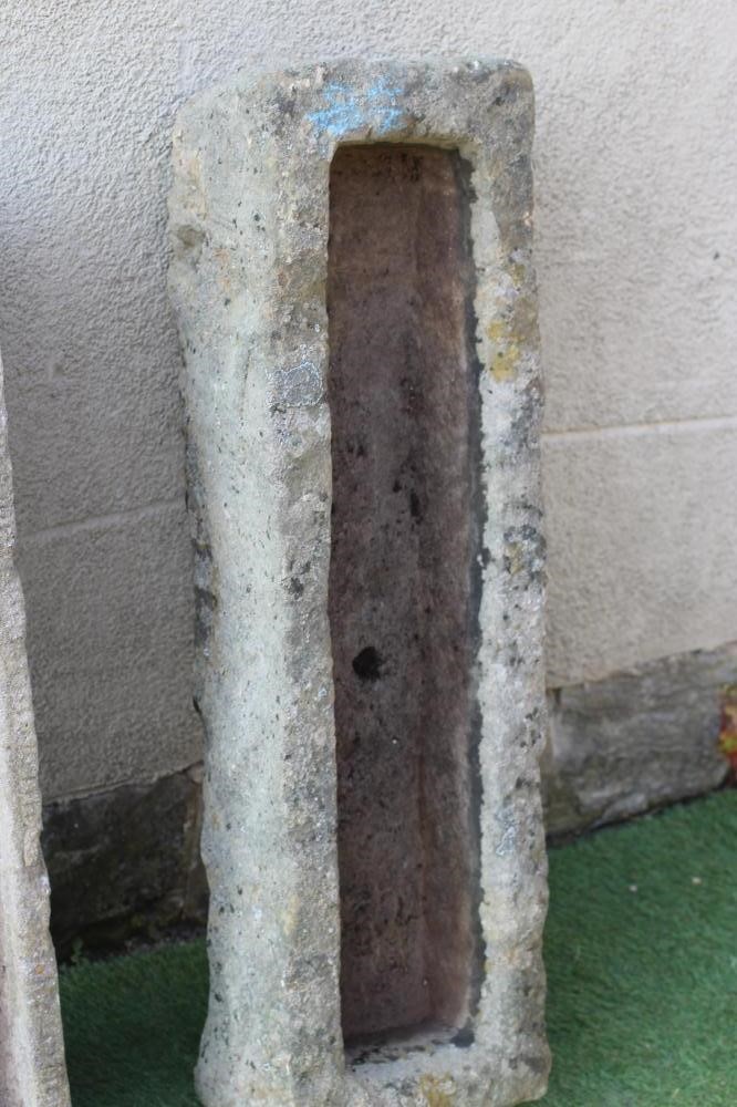 A SANDSTONE TROUGH of rough hewn narrow oblong form, 39 1/2" x 12"x 9", together with a similar Image