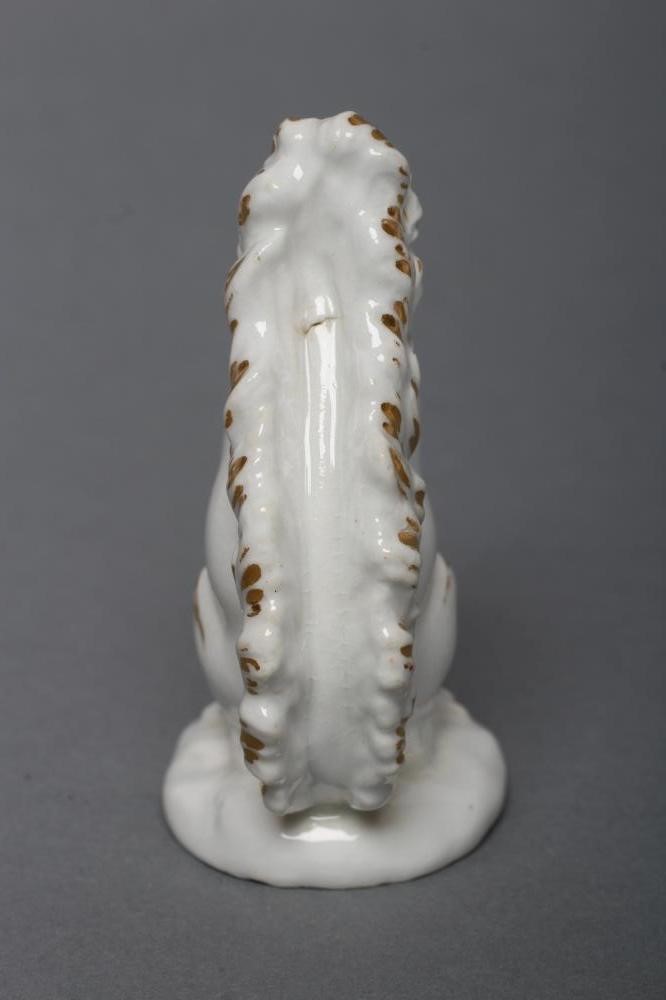 A DERBY PORCELAIN SQUIRREL, c.1800, modelled holding a nut to its mouth, with gilded highlights, Image