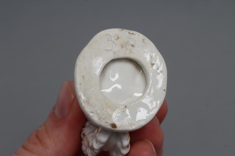 A DERBY PORCELAIN SQUIRREL, c.1800, modelled holding a nut to its mouth, with gilded highlights, Image