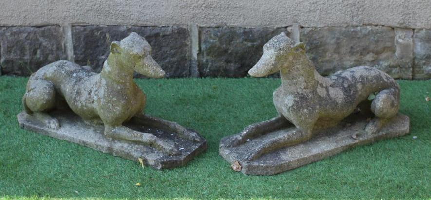 A PAIR OF CAST STONE RECUMBENT GREYHOUNDS on canted oblong bases, 27" x 10 1/2" x 16" (Est. plus 24% Image