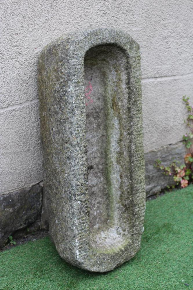 A GRANITE TROUGH of well cut narrow oblong form with rounded ends, 32" x 12" x 8 1/2" (Est. plus 24% Image