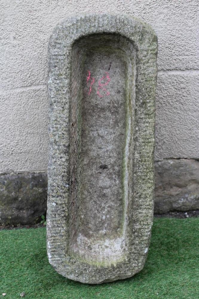 A GRANITE TROUGH of well cut narrow oblong form with rounded ends, 32" x 12" x 8 1/2" (Est. plus 24% Image