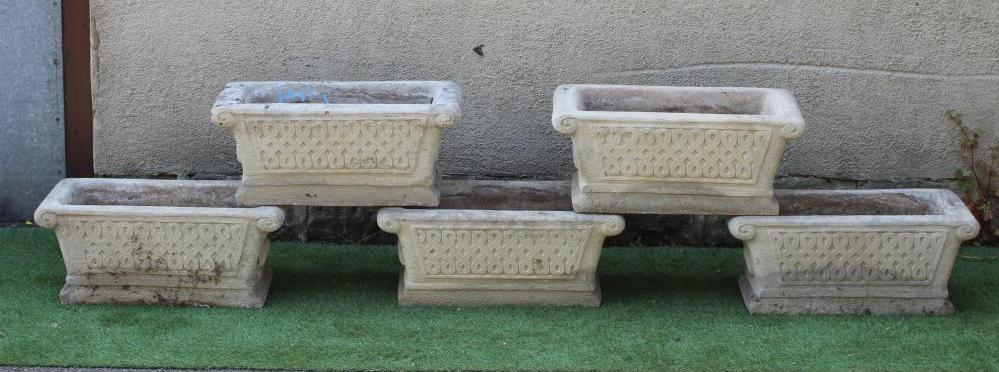 A SET OF FIVE CAST STONE JARDINIERES of oblong form with scrolled rim, featuring trellis panels and Image
