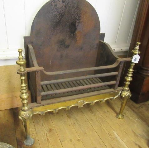 A BAROQUE STYLE CAST IRON AND BRASS FIRE BASKET Image