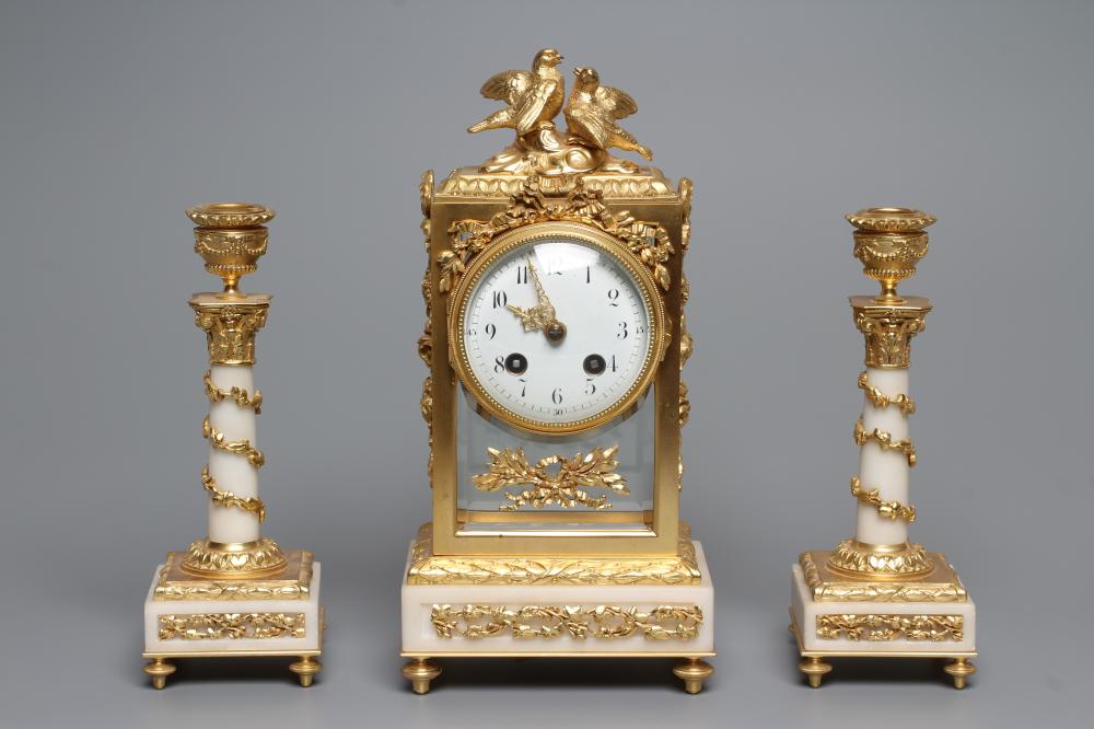 A GILT METAL AND ALABASTER CLOCK GARNITURE Image