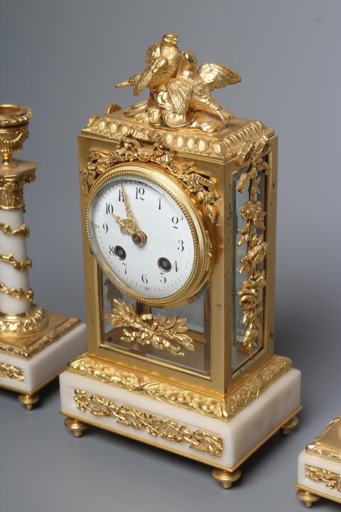 A GILT METAL AND ALABASTER CLOCK GARNITURE Image