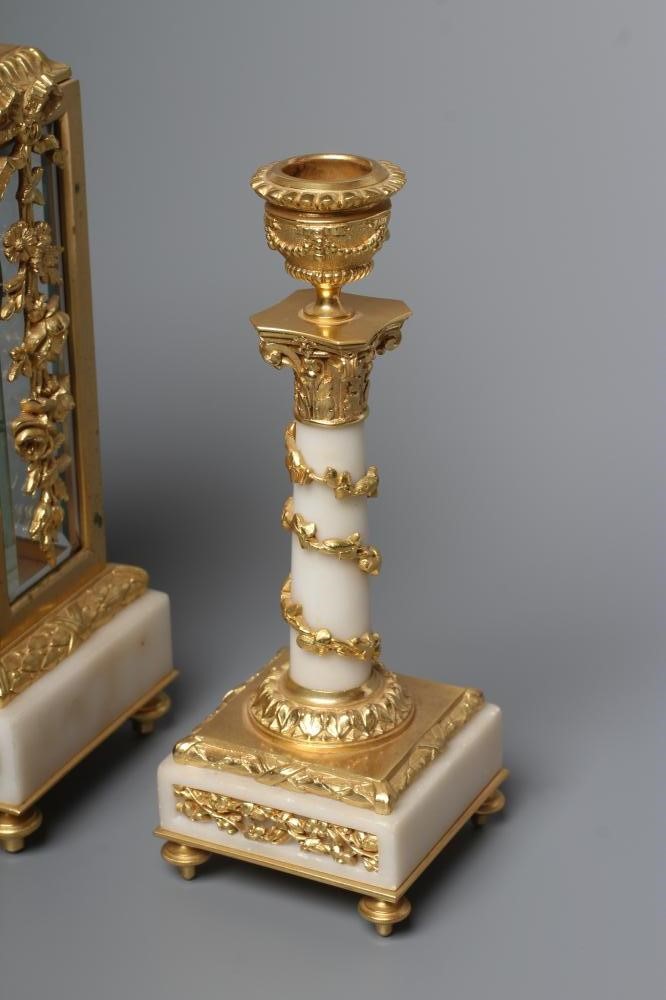 A GILT METAL AND ALABASTER CLOCK GARNITURE Image