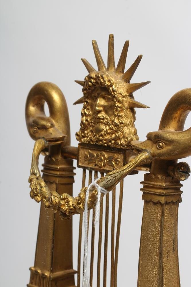 A LOUIS XVI STYLE GILT METAL LYRE MANTEL CLOCK Image
