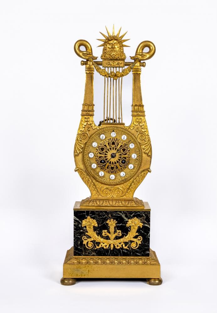 A LOUIS XVI STYLE GILT METAL LYRE MANTEL CLOCK Image
