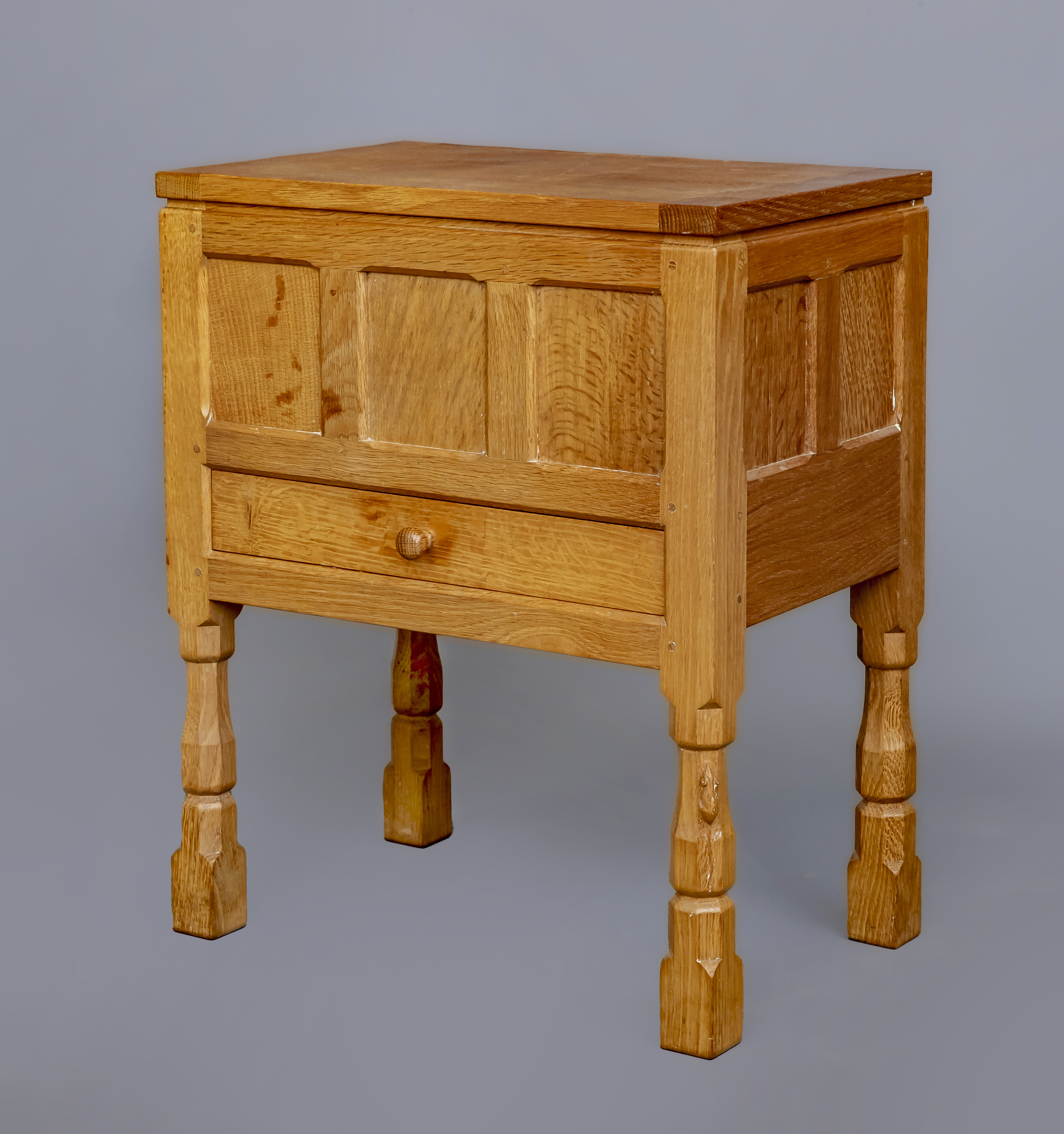 A ROBERT THOMPSON ADZED OAK WORKBOX of oblong panelled form Image