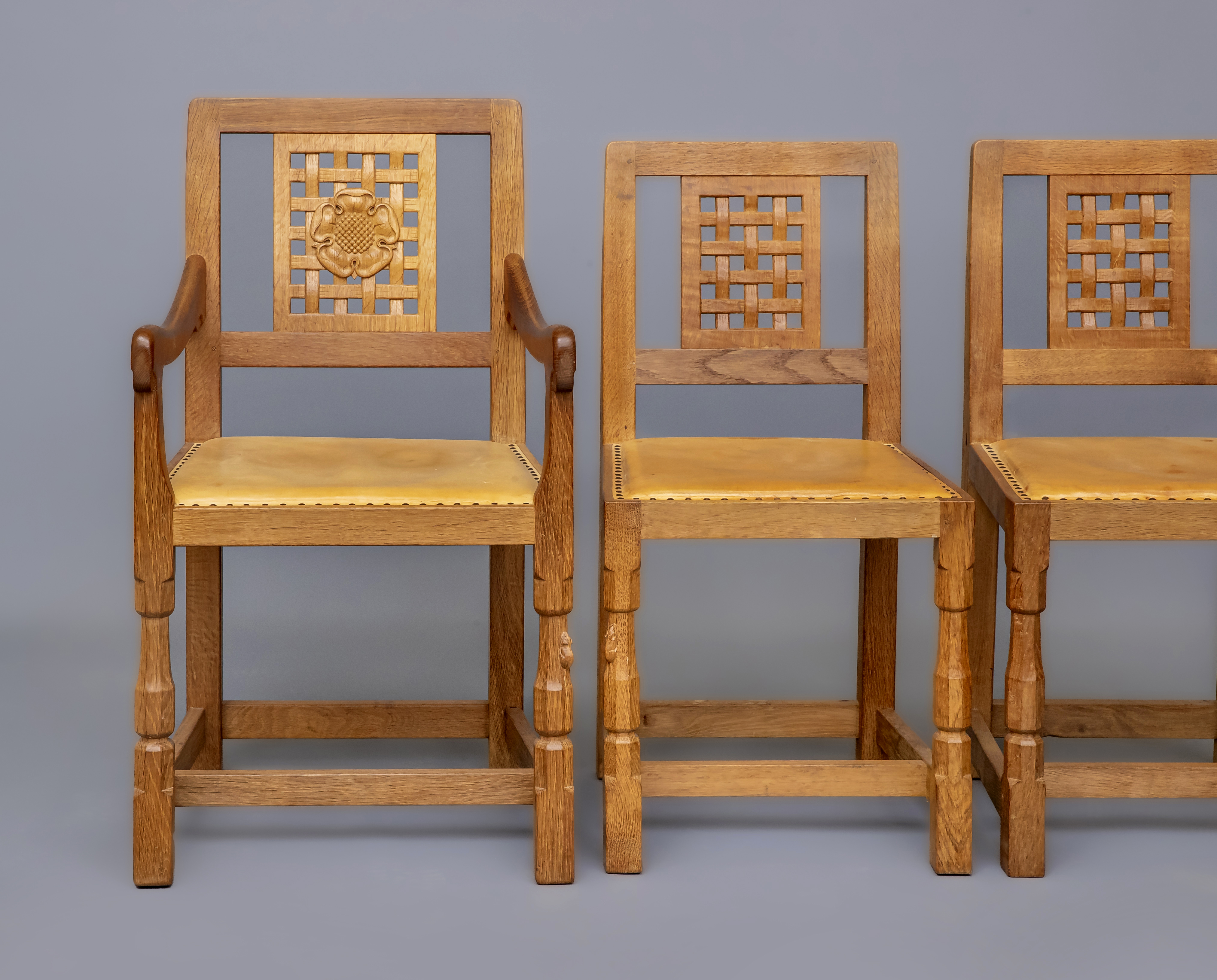 A ROBERT THOMPSON SET OF SIX OAK DINING CHAIRS including two elbow chairs Image
