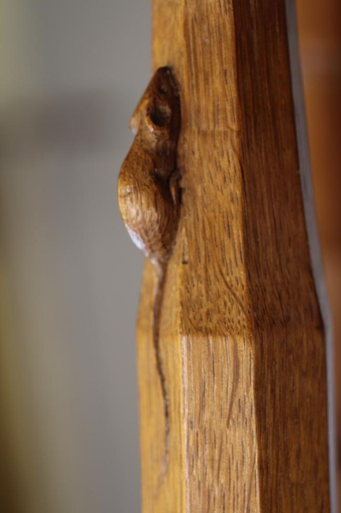 A ROBERT THOMPSON ADZED OAK STOOL of oblong form with padded cow hide seat Image