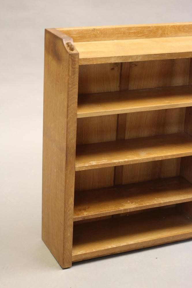 A ROBERT THOMPSON ADZED OAK OPEN BOOKCASE of oblong form with three quarter galleried top Image
