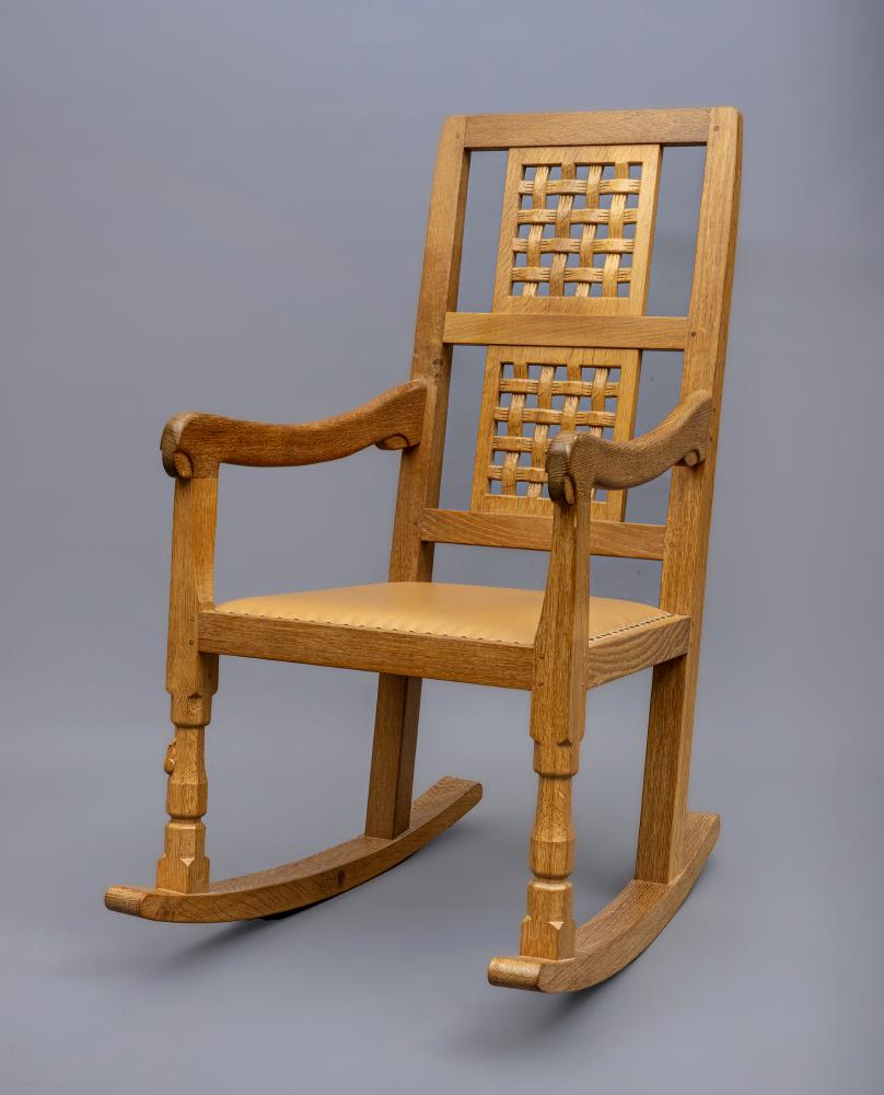 A ROBERT THOMPSON OAK ROCKING CHAIR Image