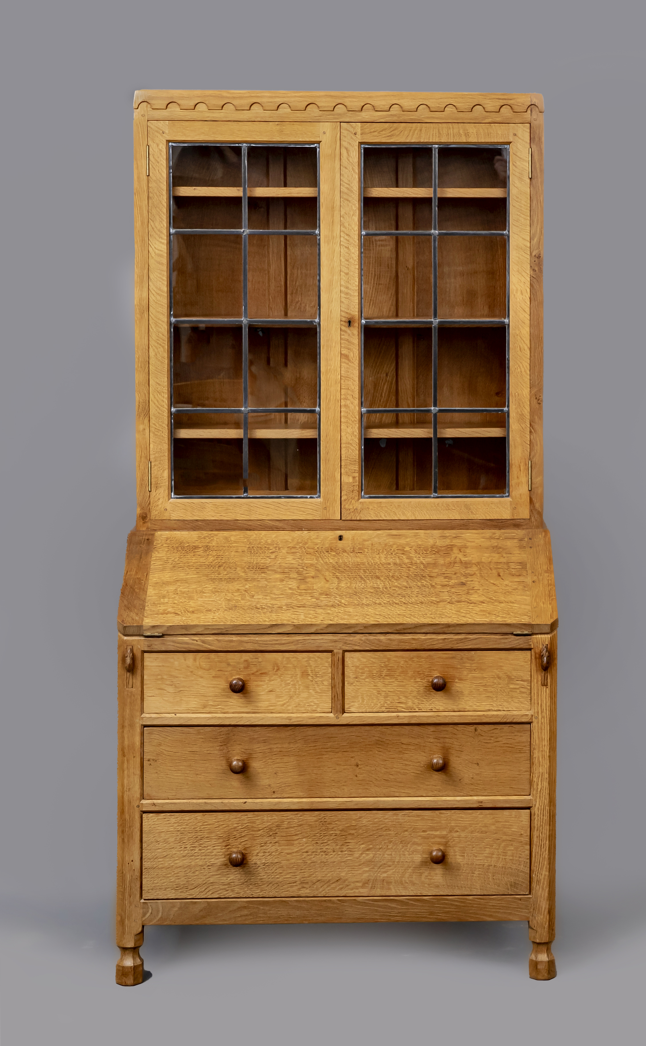 A ROBERT THOMPSON ADZED OAK BUREAU BOOKCASE Image