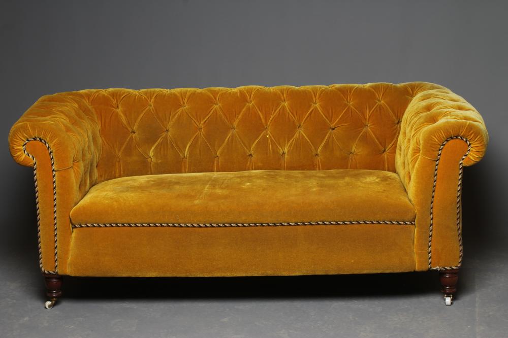 A VICTORIAN WALNUT FRAMED CHESTERFIELD DROP END SETTEE button upholstered in mustard yellow Image