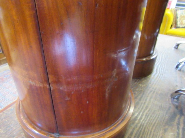 A PAIR OF VICTORIAN MAHOGANY BEDSIDE CABINETS of cylindrical form with inset veined white marble top Image
