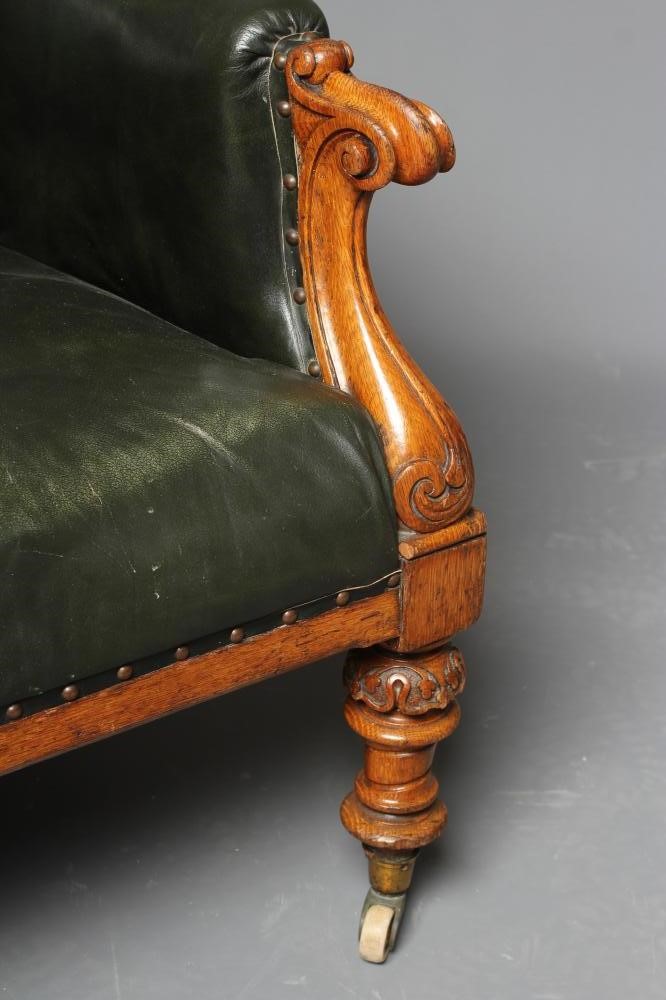 AN MID VICTORIAN OAK FRAMED ARMCHAIR button upholstered in green leather Image