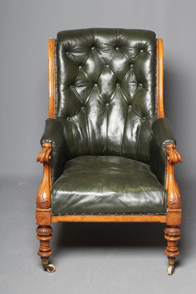 AN MID VICTORIAN OAK FRAMED ARMCHAIR button upholstered in green leather Image
