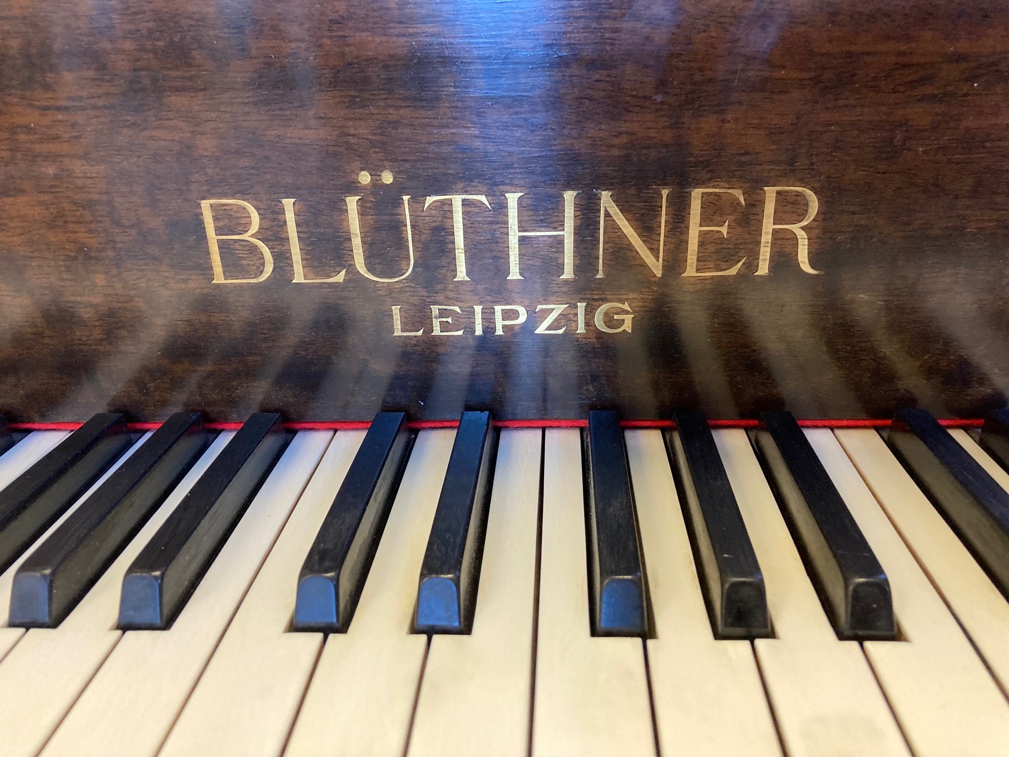 A BLUTHNER BABY GRAND PIANO Image