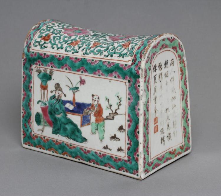 A CANTONESE PORCELAIN FAMILLE ROSE PILLOW of domed oblong form with one quatrefoil pierced end Image