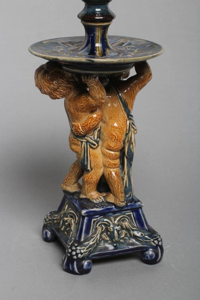 A STONEWARE FIGURAL CANDLESTICK Image