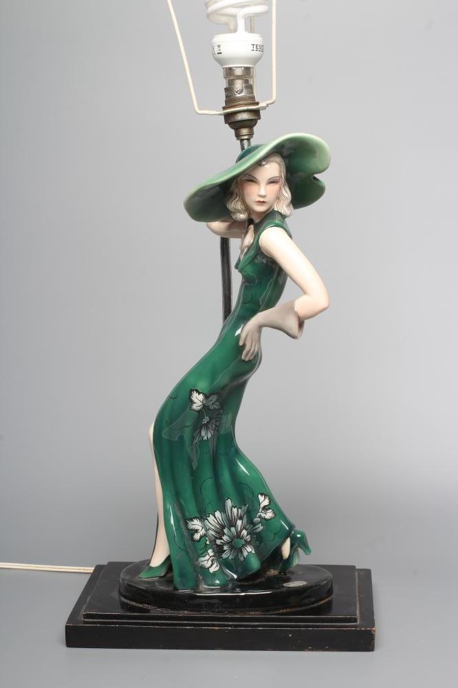 AN ART DECO GOLDSCHEIDER EARTHENWARE FIGURE modelled as a young fashionable lady wearing a wide Image