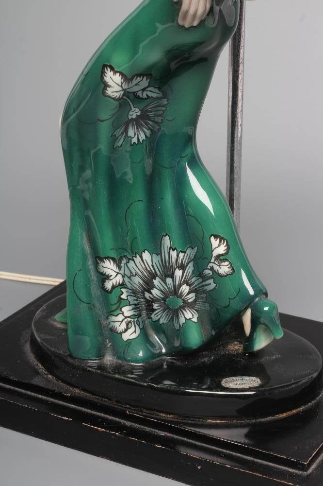 AN ART DECO GOLDSCHEIDER EARTHENWARE FIGURE modelled as a young fashionable lady wearing a wide Image