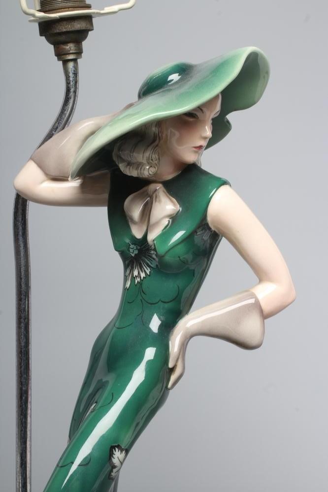 AN ART DECO GOLDSCHEIDER EARTHENWARE FIGURE modelled as a young fashionable lady wearing a wide Image
