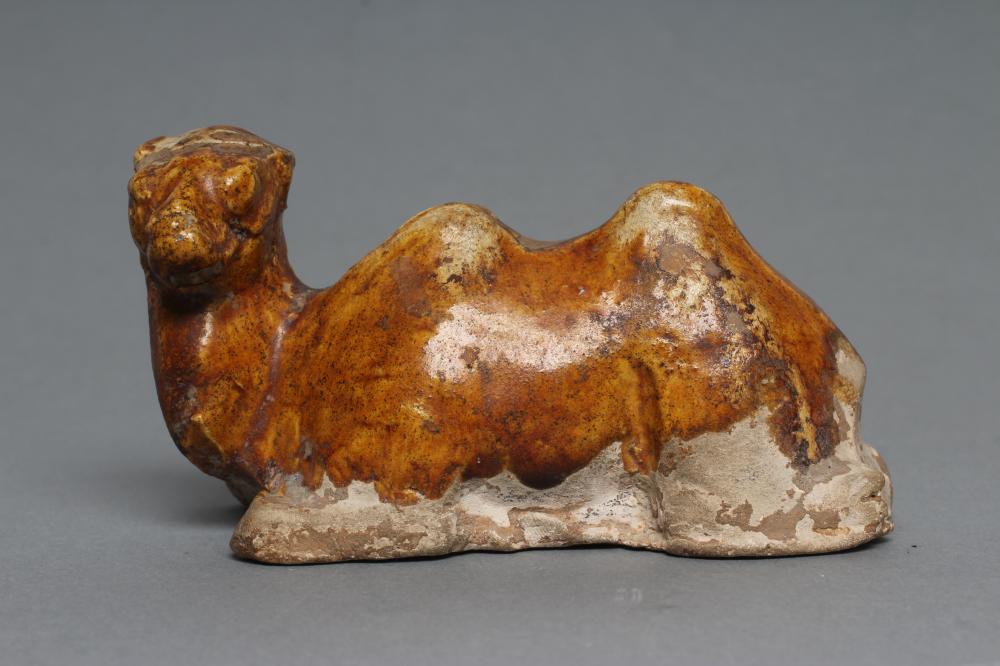 A SMALL TANG STYLE RECUMBENT CAMEL, with museum style/collectors number K61/1706 inscribed in black, Image